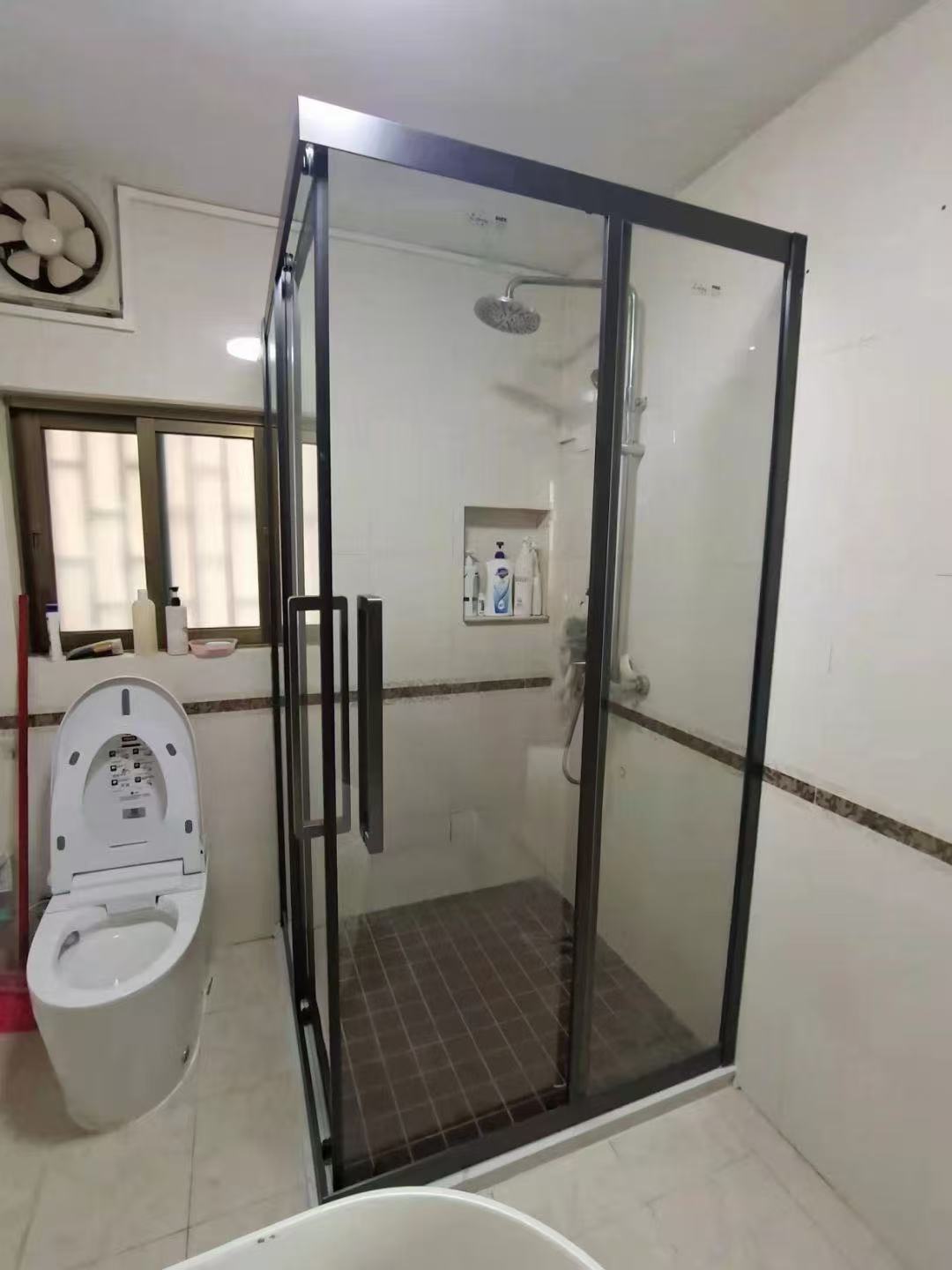 Black framed shower enclosure in a completed residential bathroom
